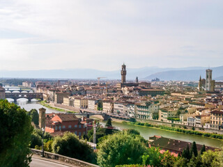 Fototapeta na wymiar Panoramic cityscape of Florence on Arno river. Famous Basilicas, churches etc from Michelangelo terrace square point. Sunny summer day view