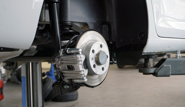 Disc brakes of a modern car. Brake disc, brake caliper. Maintenance and repair of a modern car. Spare parts.