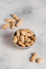 Pile of Peanuts in a bowl on a white background