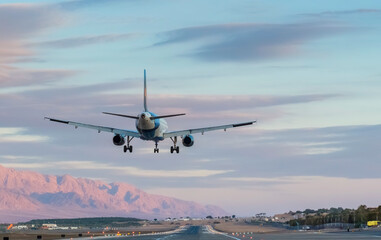 Fototapeta na wymiar Landing airplane in airport of Eilat - famous tourist resort city in Israel