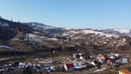 Drone shot. View of the village at the foot of the mountains. Carpathians. Ukraine.