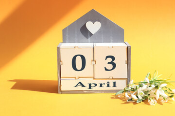 Calendar for April 3: cubes with the numbers 0 and 2, the name of the month of April in English, a...