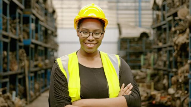 portrait of American African  Engineering woman is working in  heavy industrial plant Engine parts factory .