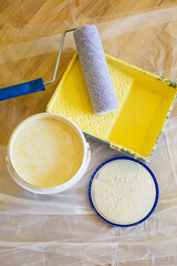 Close-up of paint roller while working indoors, renovation work
