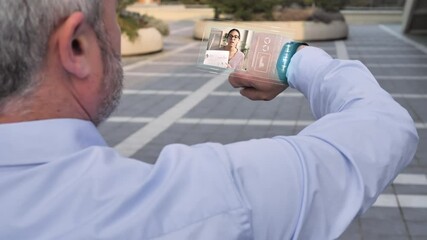 businessman using futuristic glass smart phone with augmented reality technology,future high tech holographic screen,business man turns on virtual smartphone display joining video call - Powered by Adobe