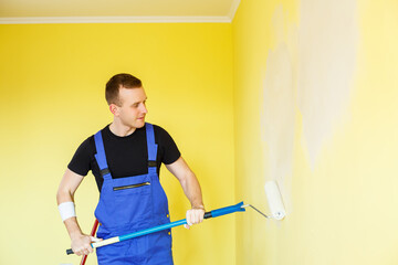 A young man makes repairs to the apartment, ok re-paints the walls in a different color