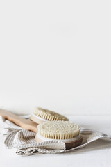 Zero waste, sustainable bathroom and lifestyle. Bamboo massage brush, loofah sponge, natural oil, DIY products in glass bottles on white background.Eco cosmetics