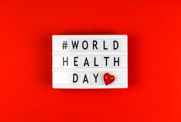 Background with World Health Day text hasgtag on lightbox, love theme and charity concept