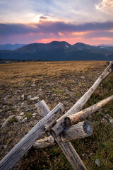 A rustic fence high in the Rocky Mountains at sunset. - 424830698