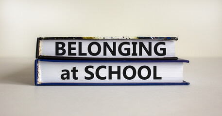 Belonging at school symbol. Books with words 'Belonging at school' on beautiful white background. Business, belonging at school concept. Copy space.