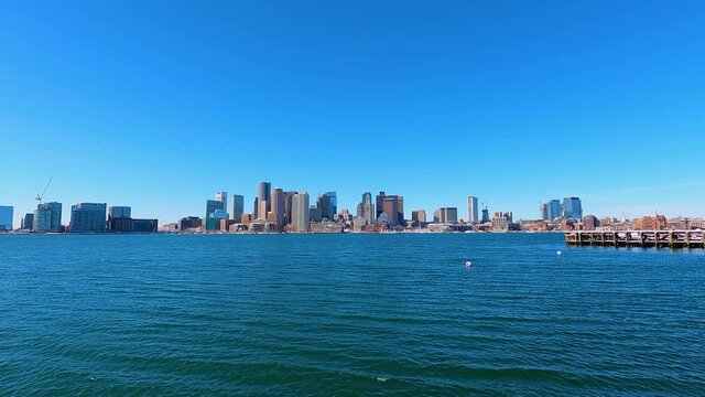 Boston financial district skyline including historic Custom House and Boston Harbor from East Boston, Massachusetts MA, USA. 