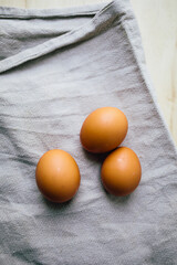 brown eggs on the table, linen cloth 