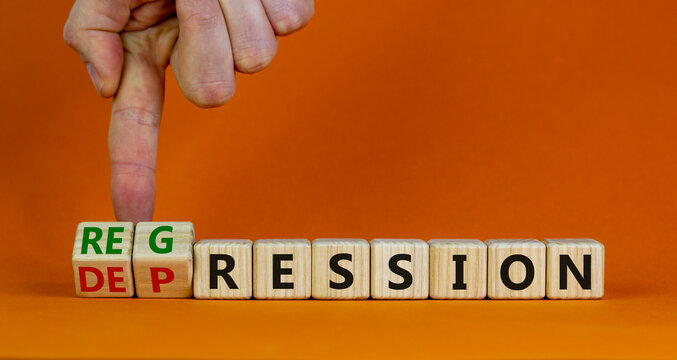 Depression or regression symbol. Doctor turns cubes and changes the word 'depression' to 'regression'. Beautiful orange background. Psychological, depression or regression concept. Copy space.