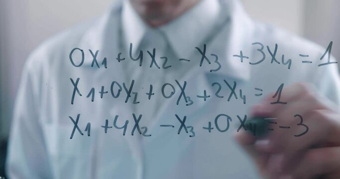 Timelapse of male scientist writes a mathematical equation with a marker on a glass board in a laboratory. The mathematician solves the problem.