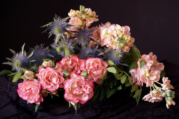 Bouquet of  flowers, pink roses, pink matthiola and blue thistles