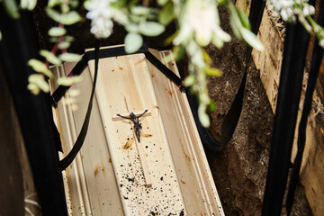 Coffin in the grave. Probably a spruce coffin. A wooden cross can still be seen and Jesus on the...