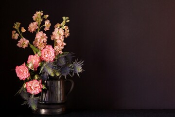 Bouquet of  flowers, pink roses, pink matthiola and blue thistles