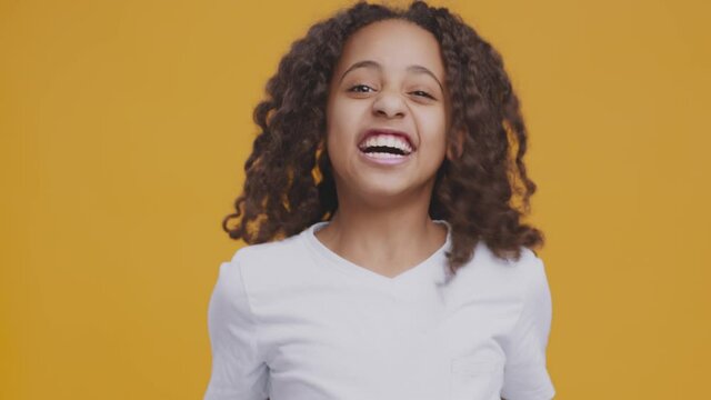 Teenage mood swings. Aggressive african american teen girl shouting and screaming, shaking her fists ro camera