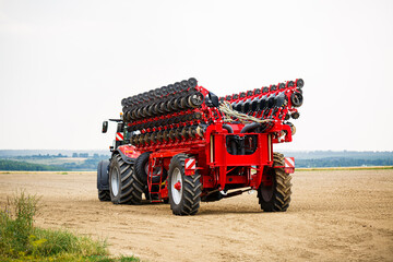 Large modern tractor for preparing the field after winter for sowing grain. Agricultural machinery