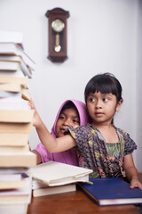 Happy two little girls reading a books, Learning from home during the pandemic