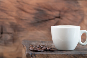 caffee cup and coffee beans on a rustic wooden background