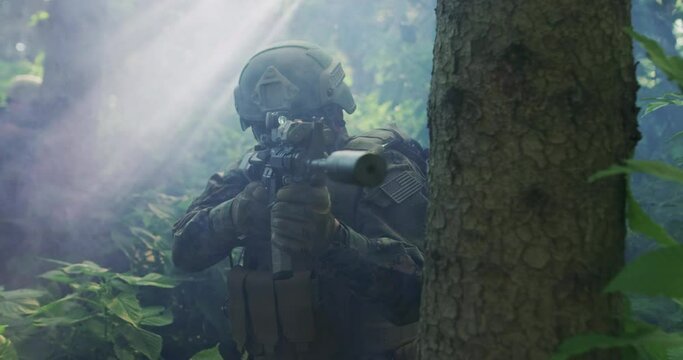 Silhouette of the Fully Equipped Soldier Moving Through Smokey Forest. Military action