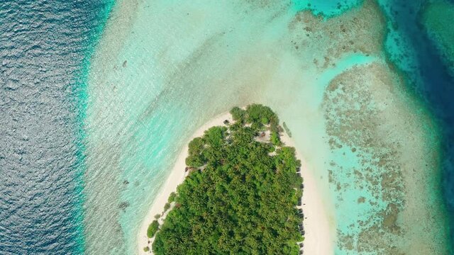 Aerial view of a tropical island in the Indian Ocean. Thinadhoo (Vaavu Atoll), Maldives