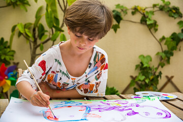 Watercolor Painting Outdoors.
Children Doing Watercolor Artwork Outdoors For Homeschool Art. 
Young Boy Learning To Paint With Watercolor Crayons. Hobbies And Entertainment.