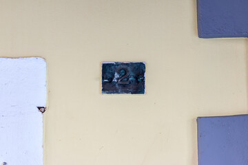 Metal plaque with number two on an old wall