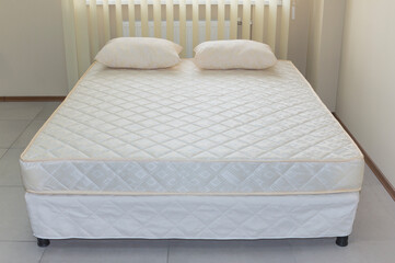 double bed frame with mattress cover and pillows