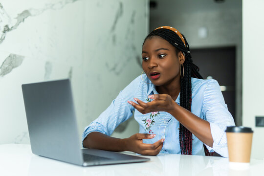 African American Woman Using Computer Laptop At Kitchen Stressed With Hand On Head, Shocked With Shame And Surprise Face, Angry And Frustrated. Fear And Upset For Mistake.