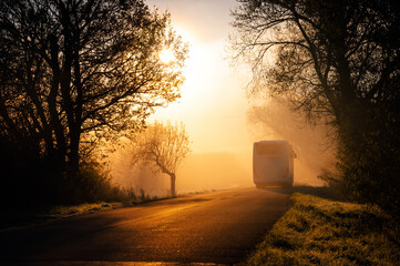 The bus or coach silhouette, public transport concept photo, autumn orange morning light