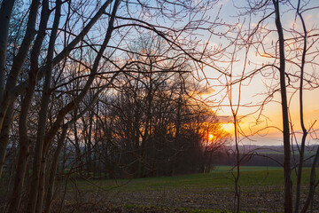 Fototapeta na wymiar Countryside looking at sunset over the far horizon during the beginning of spring season.