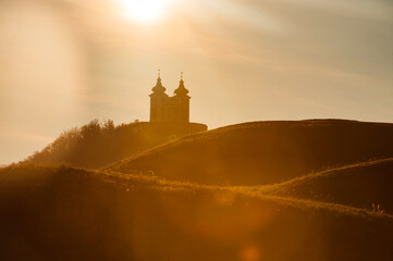 Obraz premium silhouette of Calvary church in Banska Stiavnica, Slovakia. Sunset light