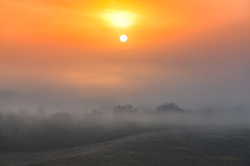 Fototapeta premium Calm autumn morning over village, rural scenery, sunset in background