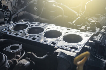 Cylinder head gasket replacement. Repair of a turbocharged diesel engine in a car workshop. Blur...