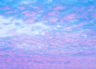Light background of pinkish cirrus clouds in the blue morning sky