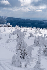Winter mountain landscape, Poland, Panorama of the Giant Mountains in sunny winter day, from Biała Dolina in Szklarska Poreba on Szrenica and Sniezne Kotly, blue sky, white and dark clouds. Snow cover