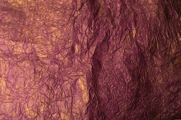 The background is made of crumpled paper in the color of Burgundy wine with gold paint.