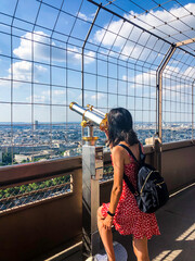 Chica mirando desde lo alto de la Torre Eiffel en París.