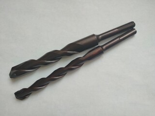 two new black concrete drill bits for a punch on a white background 