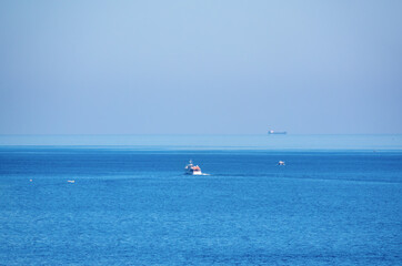 Fototapeta na wymiar Several ships in the blue calm sea.