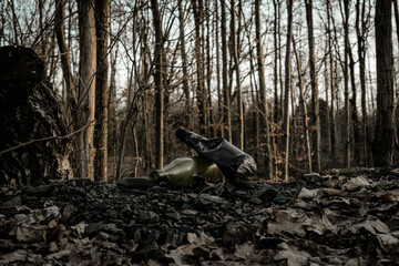 Pollution garbage in environment forest. Rubbish plastic waste on woodland. Empty used dirty bottles in the concept of nature conservation from pollution.