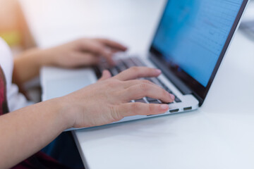 Young attractive business woman in red and black shirt enjoying alone at her office