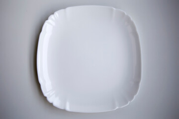 Utensils with one white ceramic glossy plate isolated over the white background