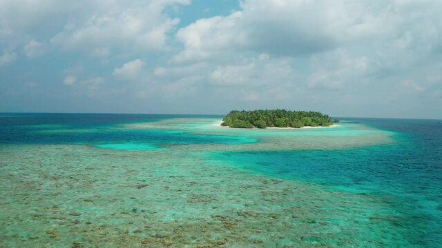 Aerial view of a tropical island in the Indian Ocean. Thinadhoo (Vaavu Atoll), Maldives