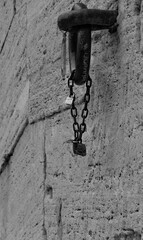 Chain with padlocks on a stone wall