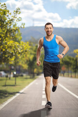 Man jogging and smiling in the city