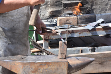 Blacksmith forged ironsmith. traditional hammer beating. Medieval blacksmith. Horseshoe workspace made with the medieval blacksmith method.