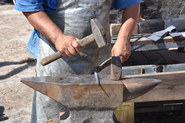 Blacksmith forged ironsmith. traditional hammer beating. Medieval blacksmith. Horseshoe workspace made with the medieval blacksmith method.